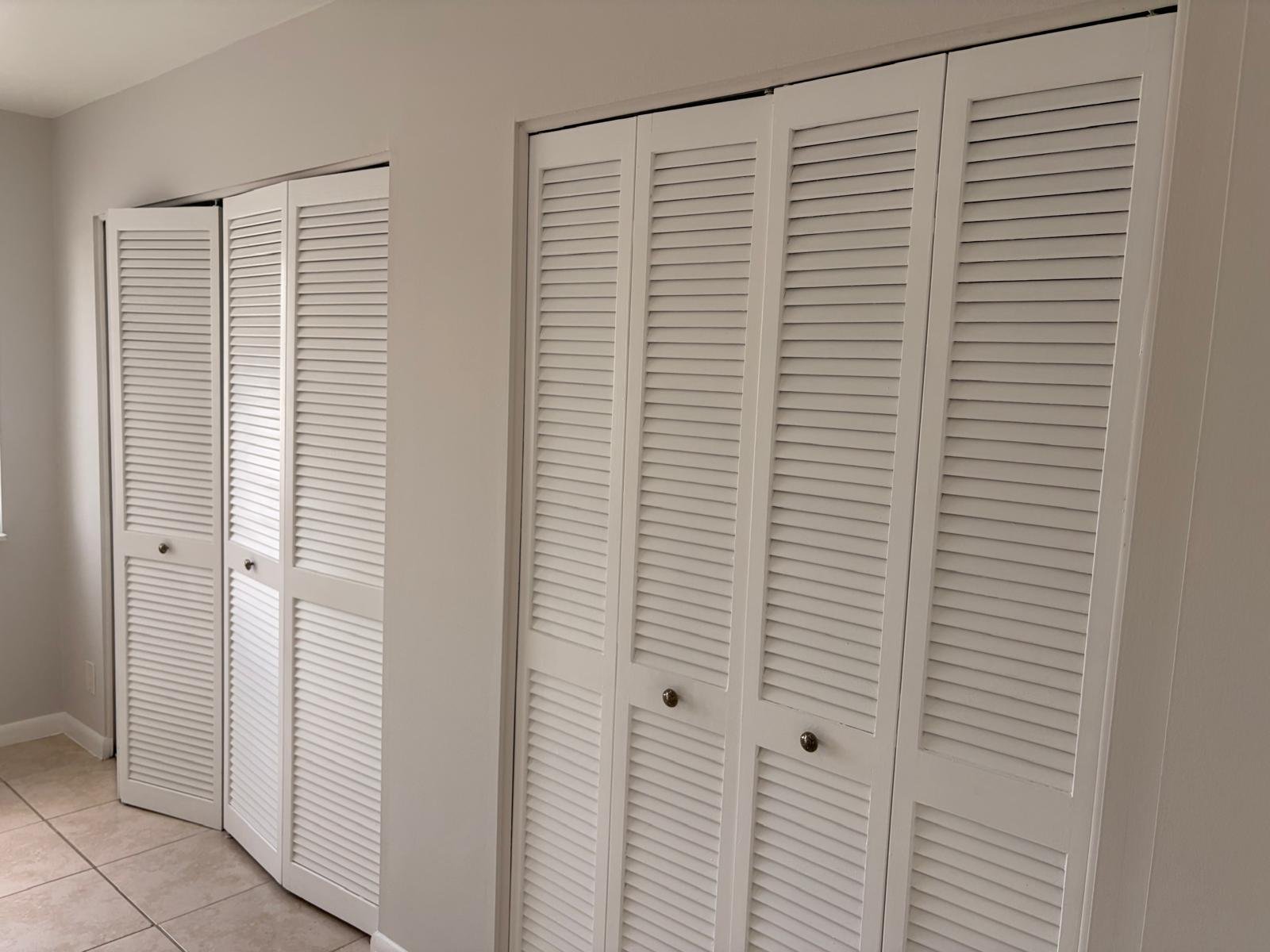 Painted white louvered bifold closet doors in Jupiter FL