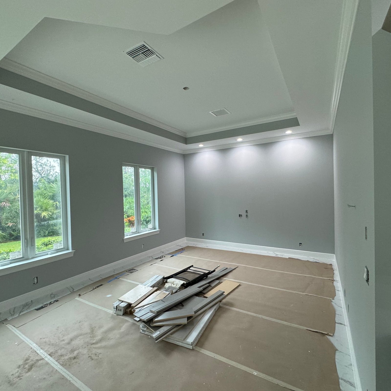 Painted great room with vaulted tray ceiling and recessed lighting in Jupiter FL