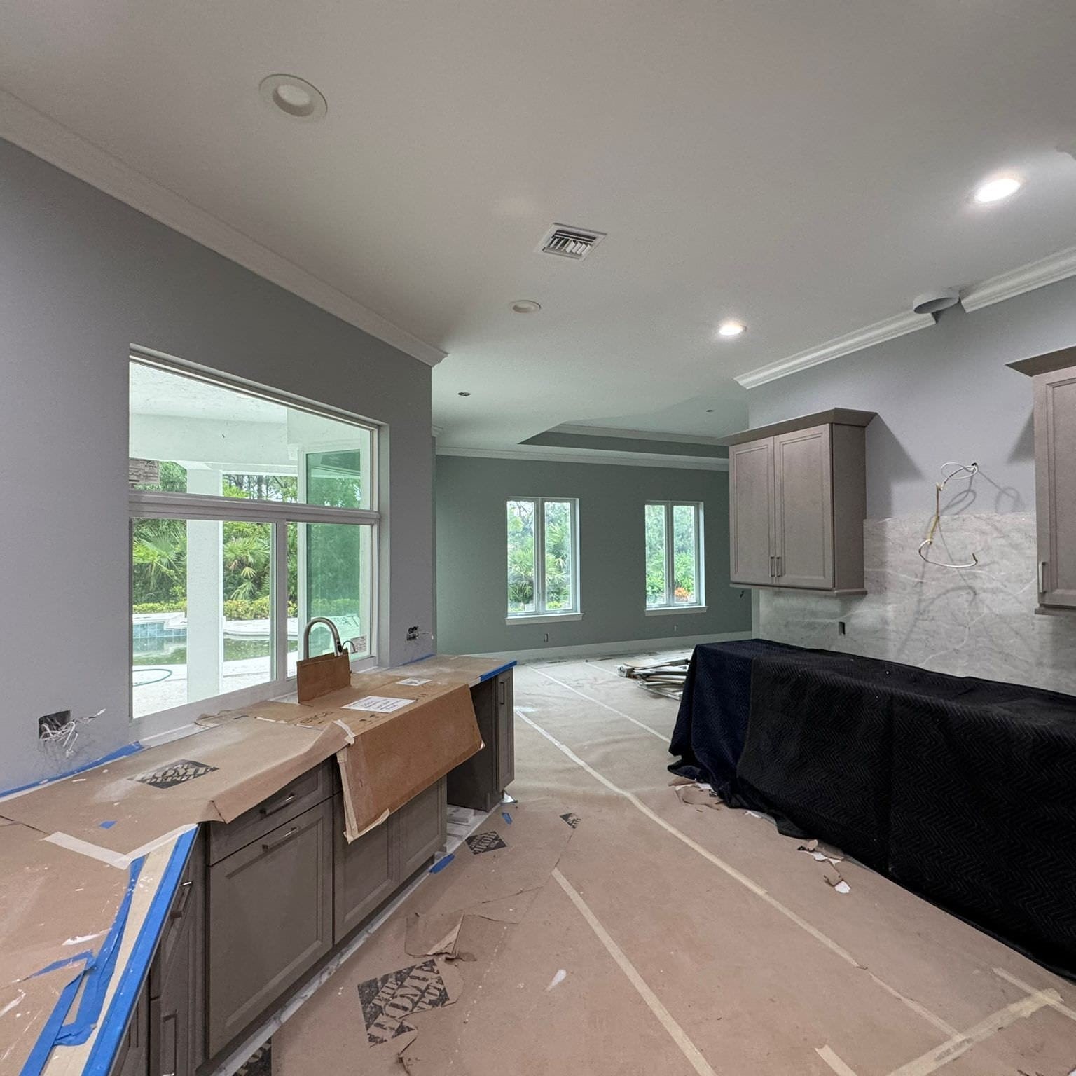 Kitchen and open living room interior repaint with protected countertops in Jupiter FL