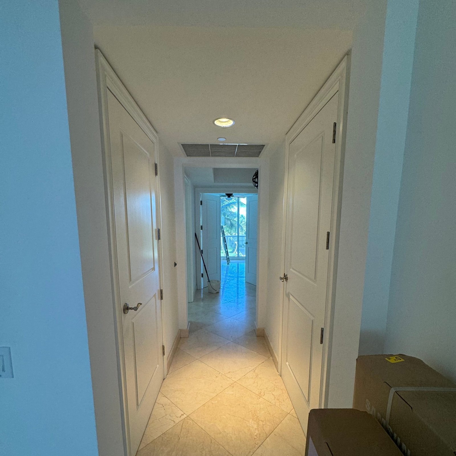 Residential interior hallway with painted white doors and casings in Jupiter FL