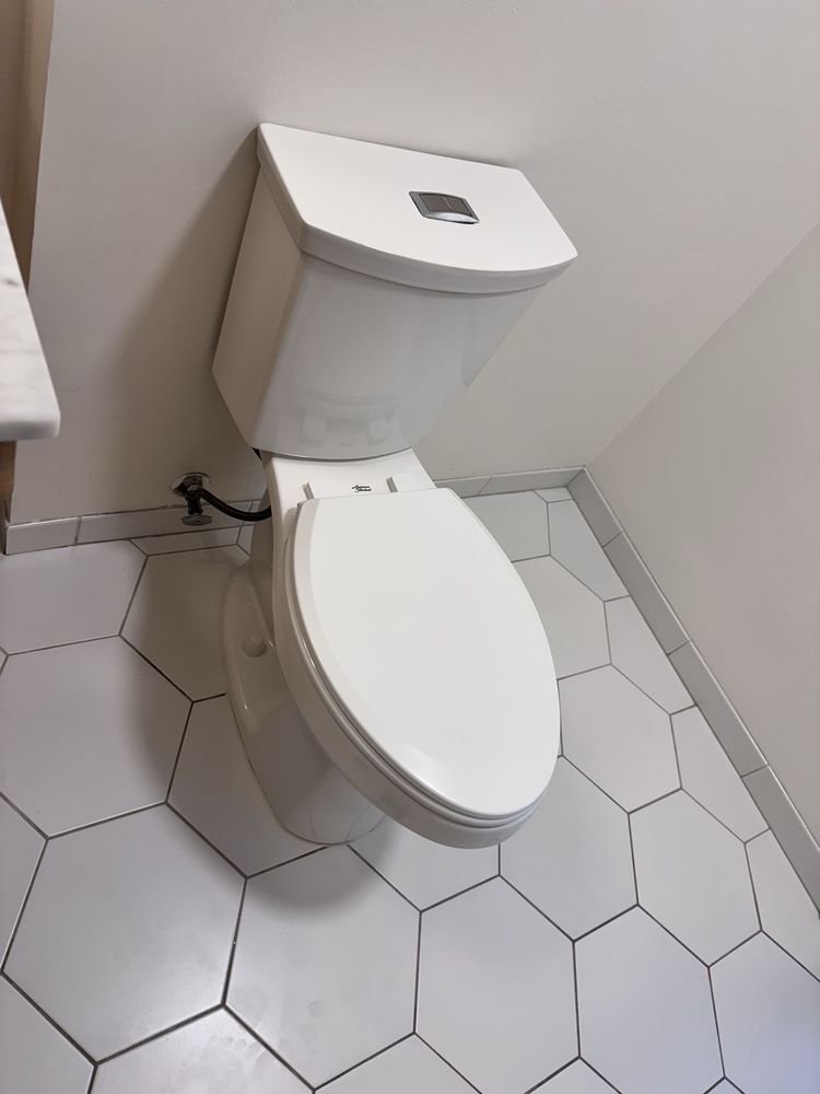 White hexagon floor tile installation in residential bathroom in Jupiter FL