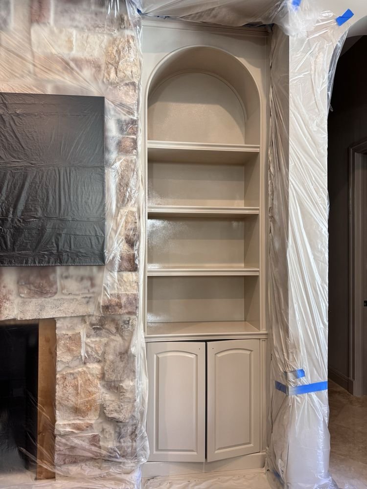 Custom painted arched built-in bookcases and stone fireplace in Jupiter FL