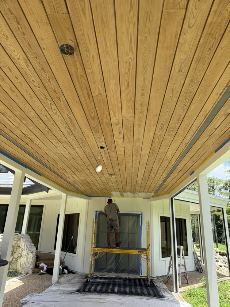 Wood plank tongue-and-groove lanai ceiling installation with scaffolding in Jupiter FL