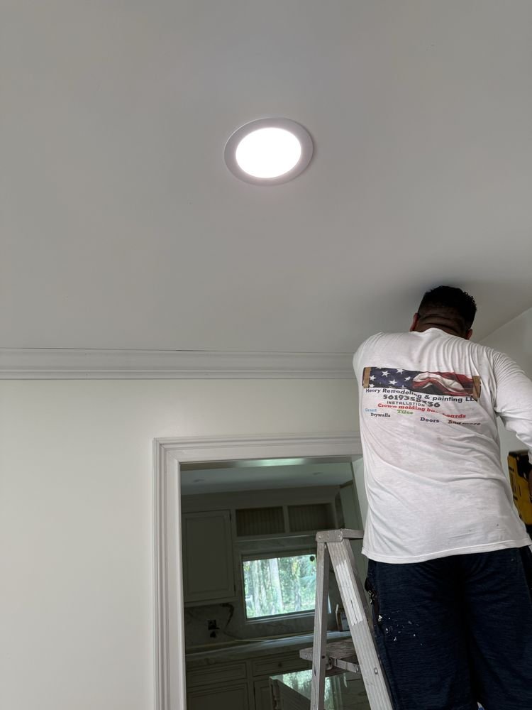 Henry in branded uniform installing crown molding with precision in Jupiter FL