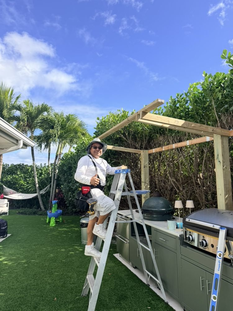 Henry on site framing outdoor kitchen pergola in uniform