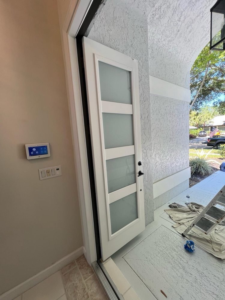Modern white front door with horizontal frosted glass panels in Jupiter FL