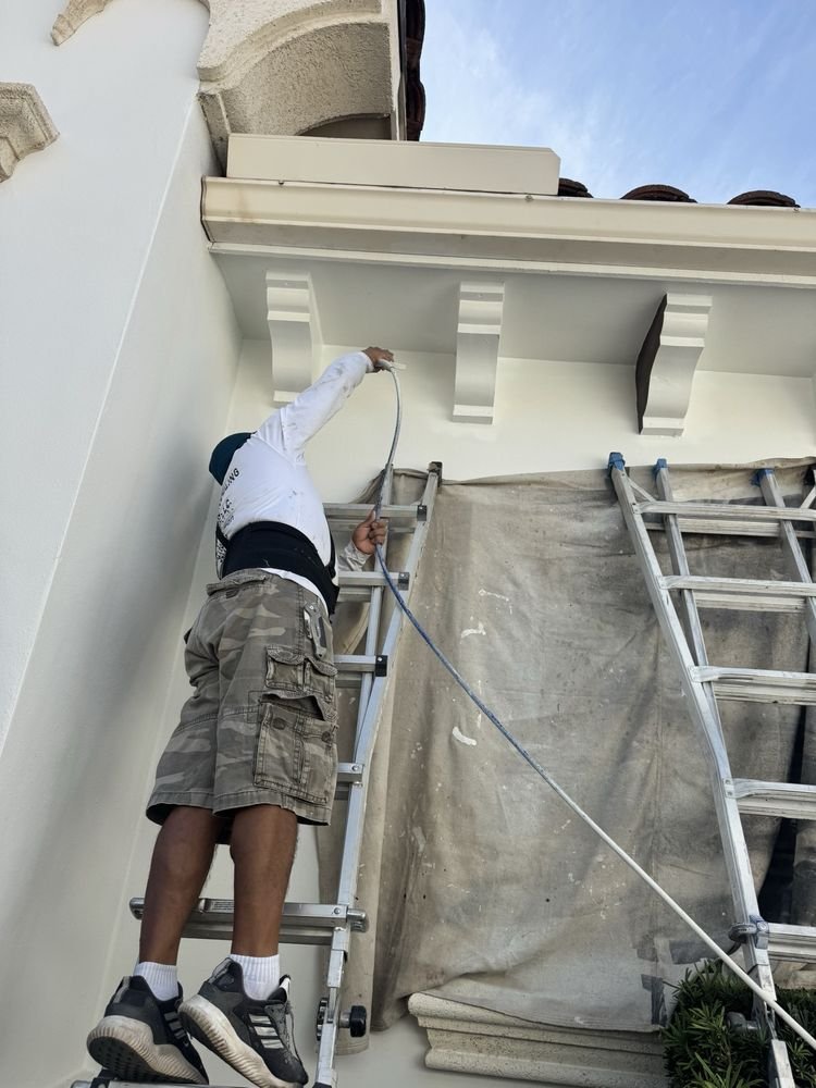 High-reach spray application on exterior corbels and soffit boards in Jupiter FL