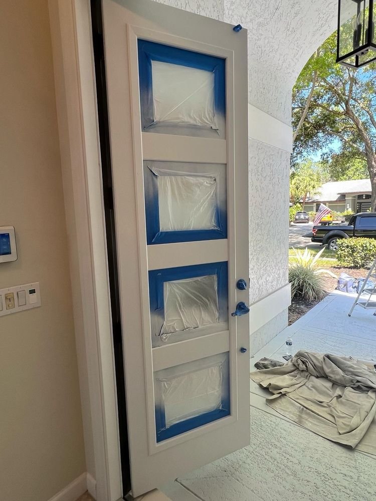 Interior front door white spray finish with masked glass panes in Jupiter FL