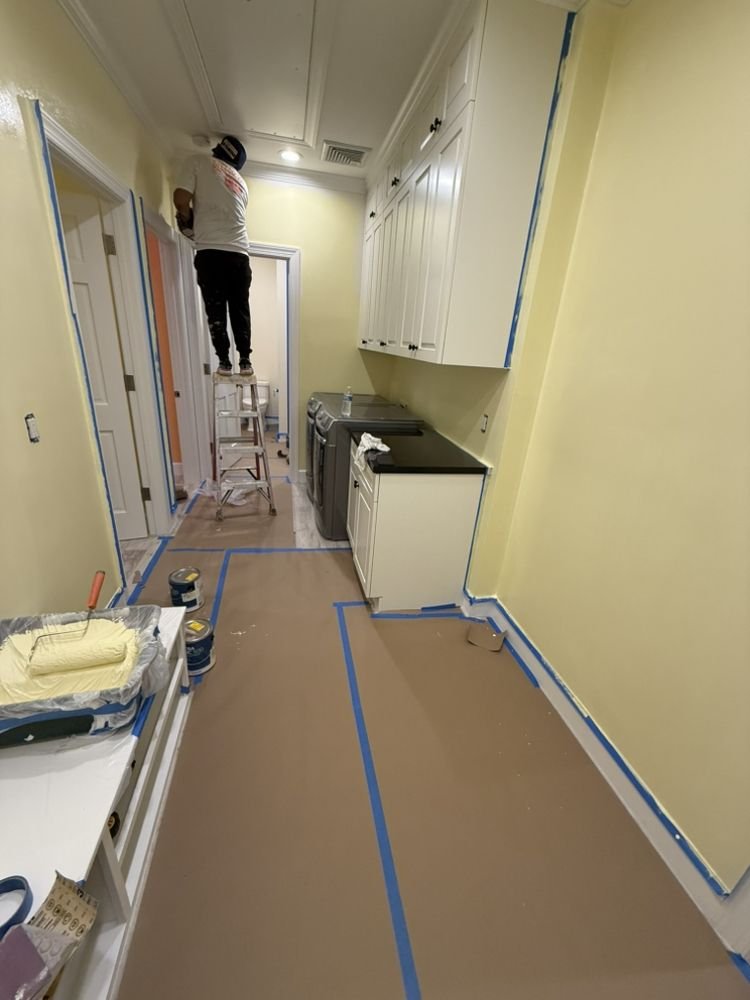 Interior laundry room painting with complete floor paper protection in Jupiter FL