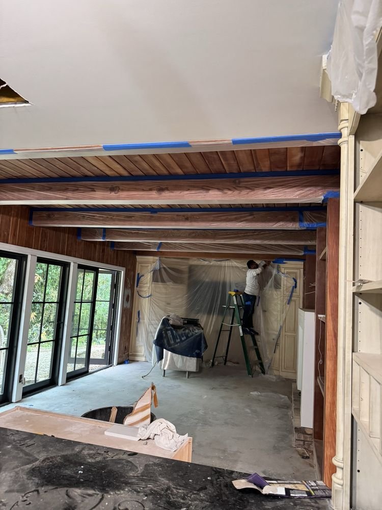 Ceiling wood beams masked with plastic sheeting for spray painting in Jupiter FL