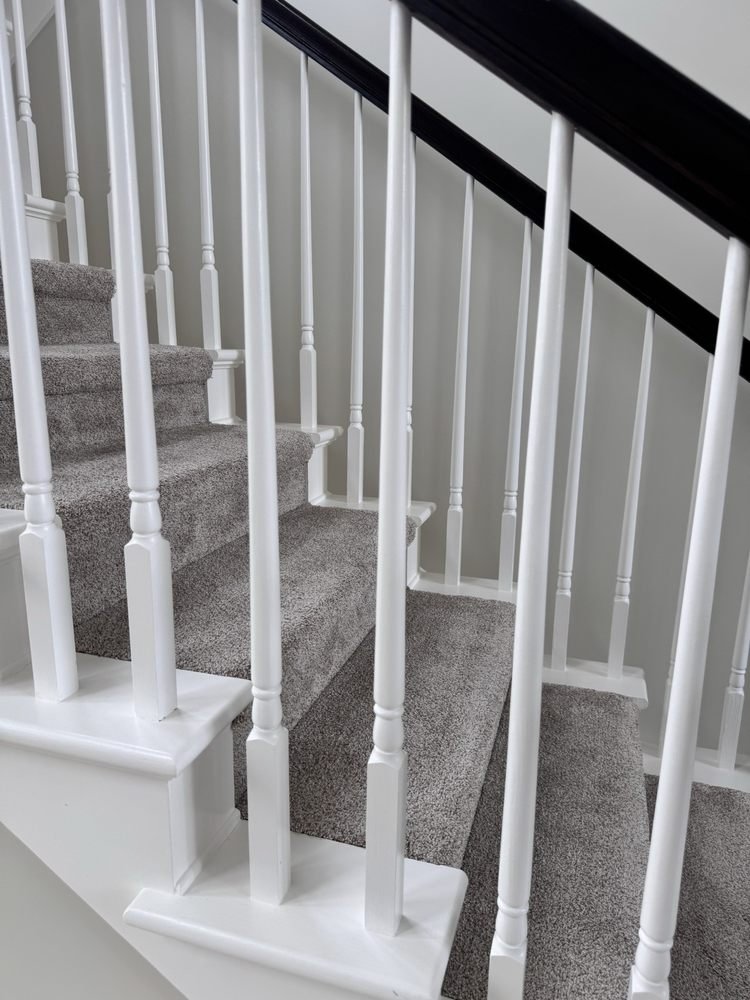 Painted interior staircase with white balusters and dark handrail in Jupiter FL