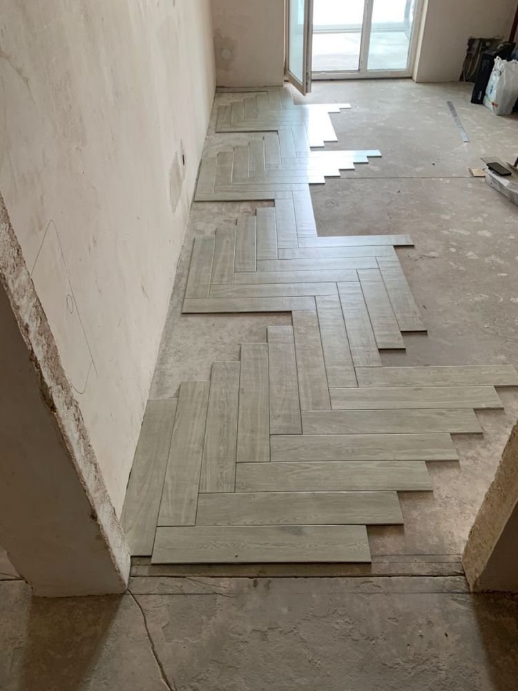 Herringbone wood-plank porcelain tile floor installation in Jupiter FL